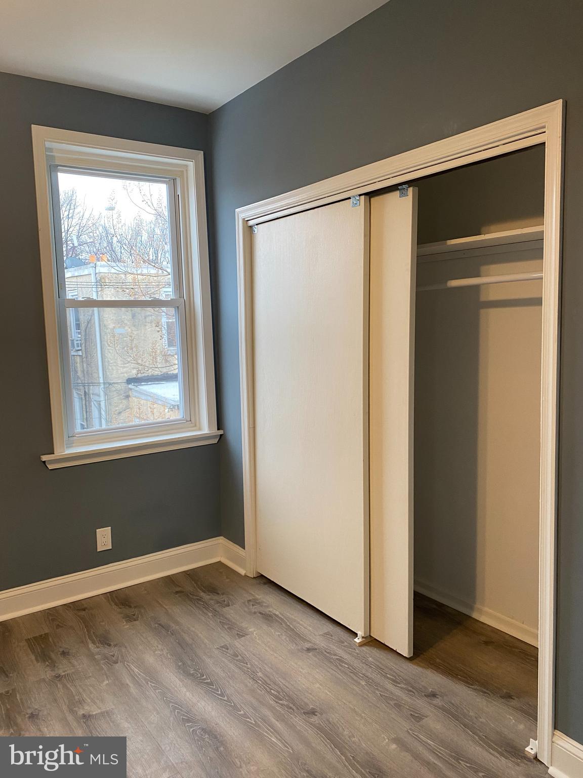 5332 Pine Street, Unit 2 Philadelphia, PA 19143 - Photo 14 of 21 a view of an empty room with wooden floor and a window