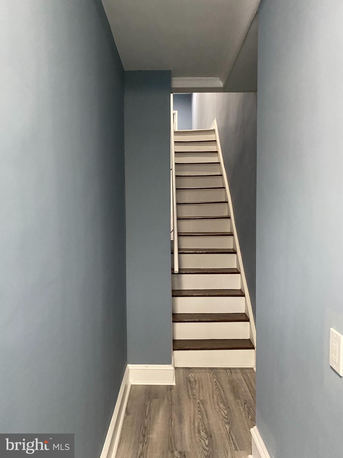 5332 Pine Street, Unit 2 Philadelphia, PA 19143 - Photo 16 of 21 a view of a hallway with stairs and wooden floor