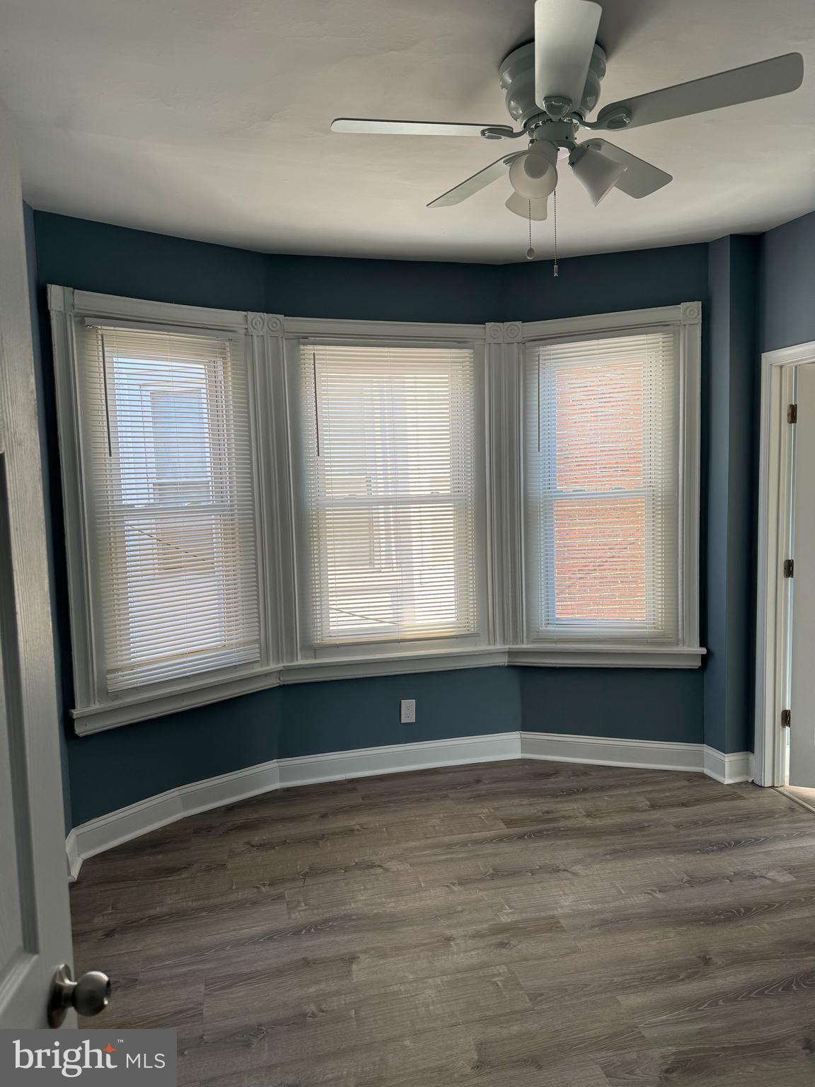 5332 Pine Street, Unit 2 Philadelphia, PA 19143 - Photo 4 of 21 a view of an empty room with a window and wooden floor
