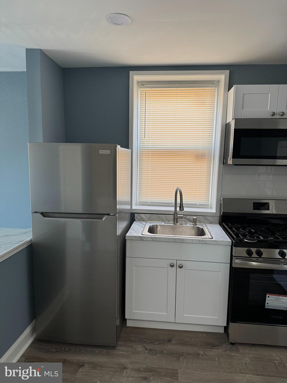 5332 Pine Street, Unit 2 Philadelphia, PA 19143 - Photo 6 of 21 a kitchen with a sink a refrigerator and a stove top oven