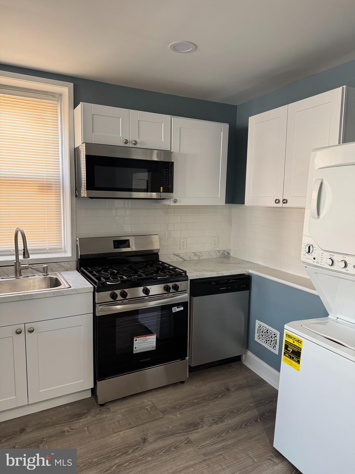 5332 Pine Street, Unit 2 Philadelphia, PA 19143 - Photo 9 of 21 a kitchen with a sink a stove and cabinets