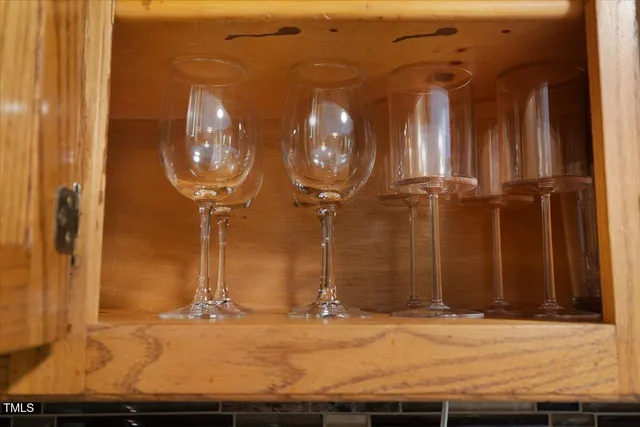 a view of staircase with lots of frames on wall and a large window