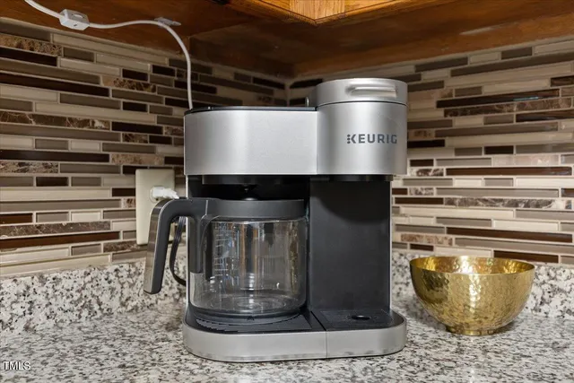 a spacious bedroom with a bed and a chandelier