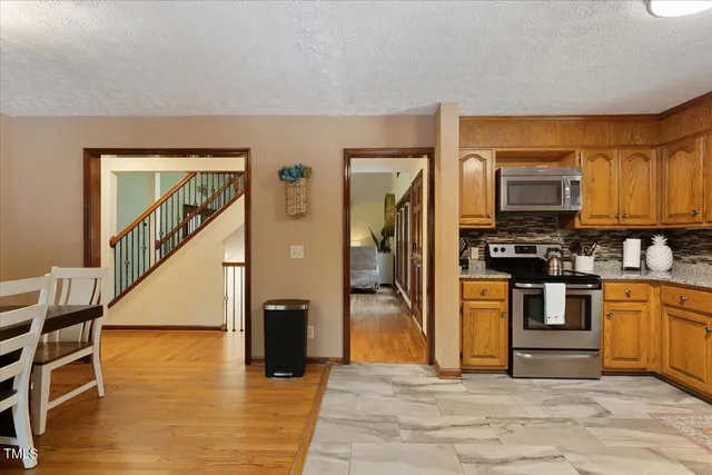 a bedroom with a bed lamp and a window