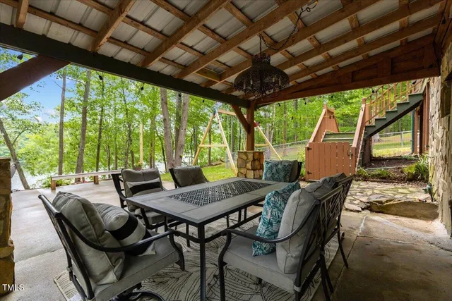 a view of a chairs and table in the balcony