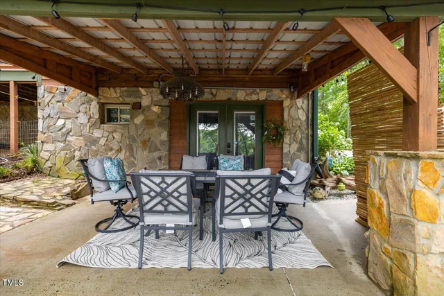 a view of a backyard with plants and large trees