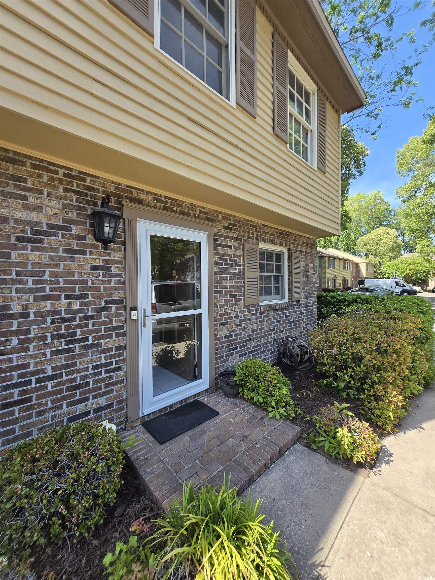 830 44th Avenue North Myrtle Beach, SC 29577 - Photo 1 of 13 Property entrance with brick siding