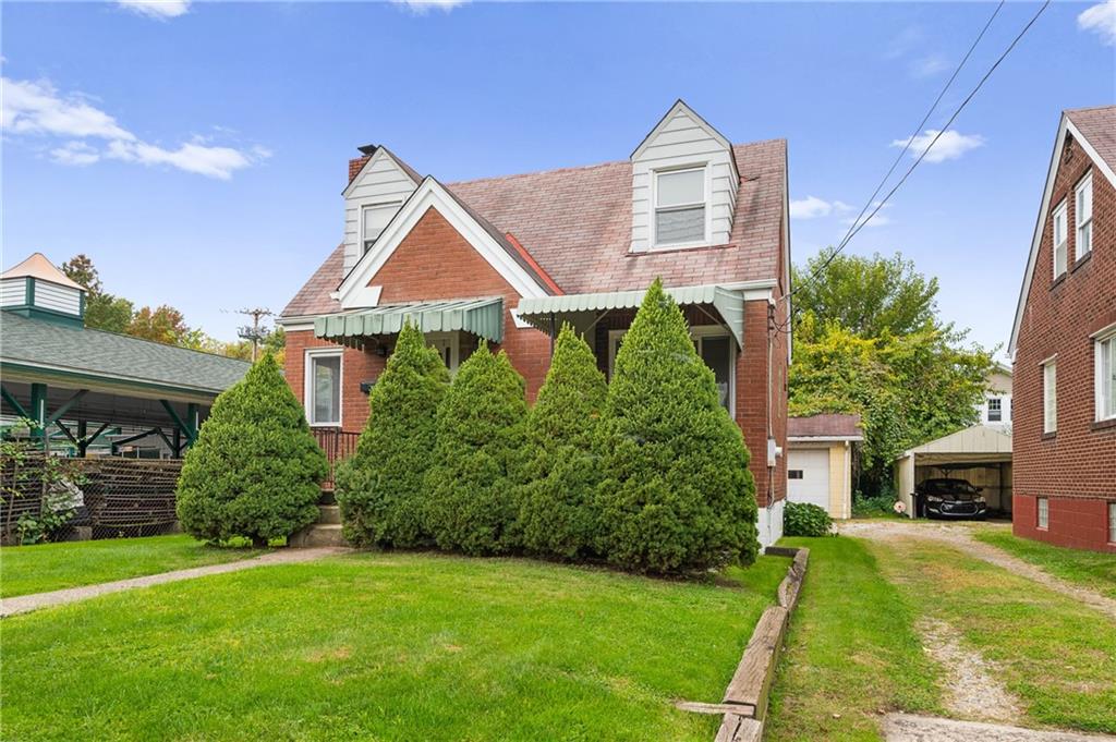 105 Delafield Road Pittsburgh, PA 15215 - Photo 18 of 18 a front view of a house with a yard and garage