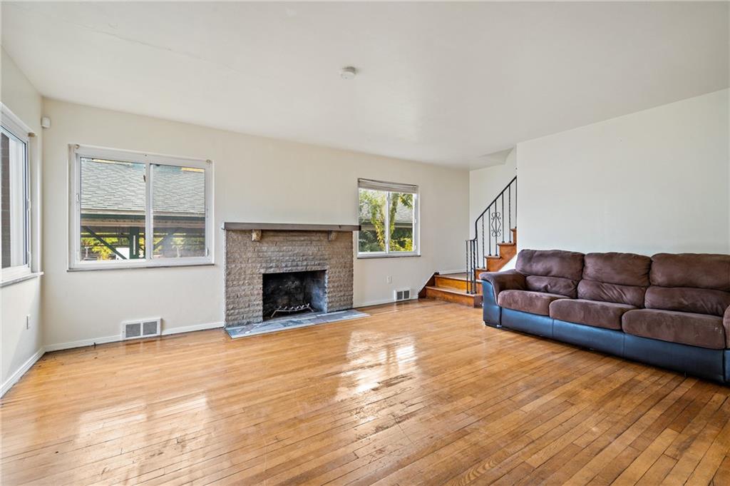 105 Delafield Road Pittsburgh, PA 15215 - Photo 7 of 18 a living room with furniture and a fireplace