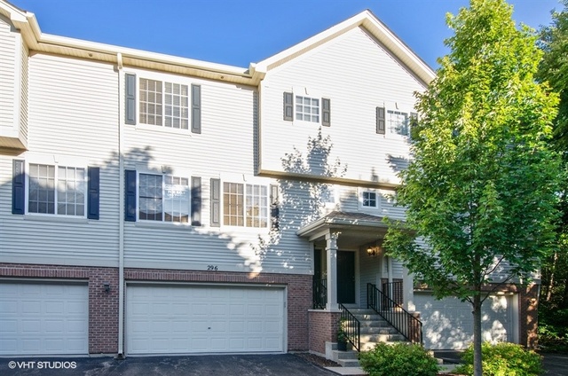 a view of a house with brick walls and potted plants