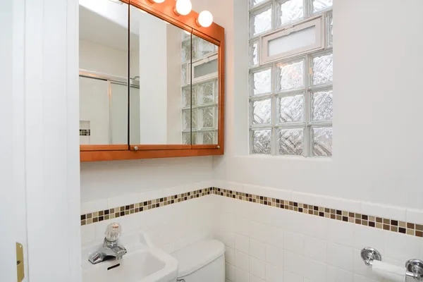 a bathroom with a shower and a window