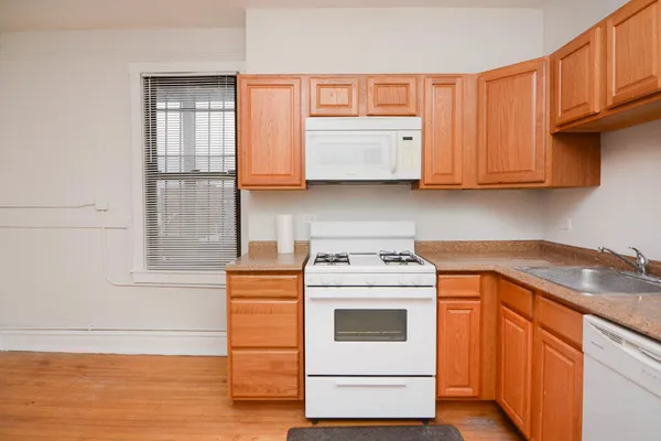 a kitchen with stainless steel appliances granite countertop a sink and a stove