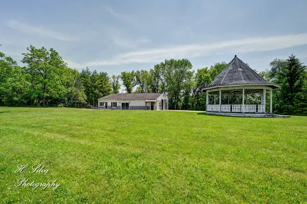 a front view of house with yard and green space