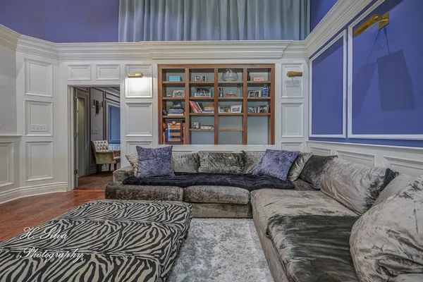 a living room with a couch and a bookshelf
