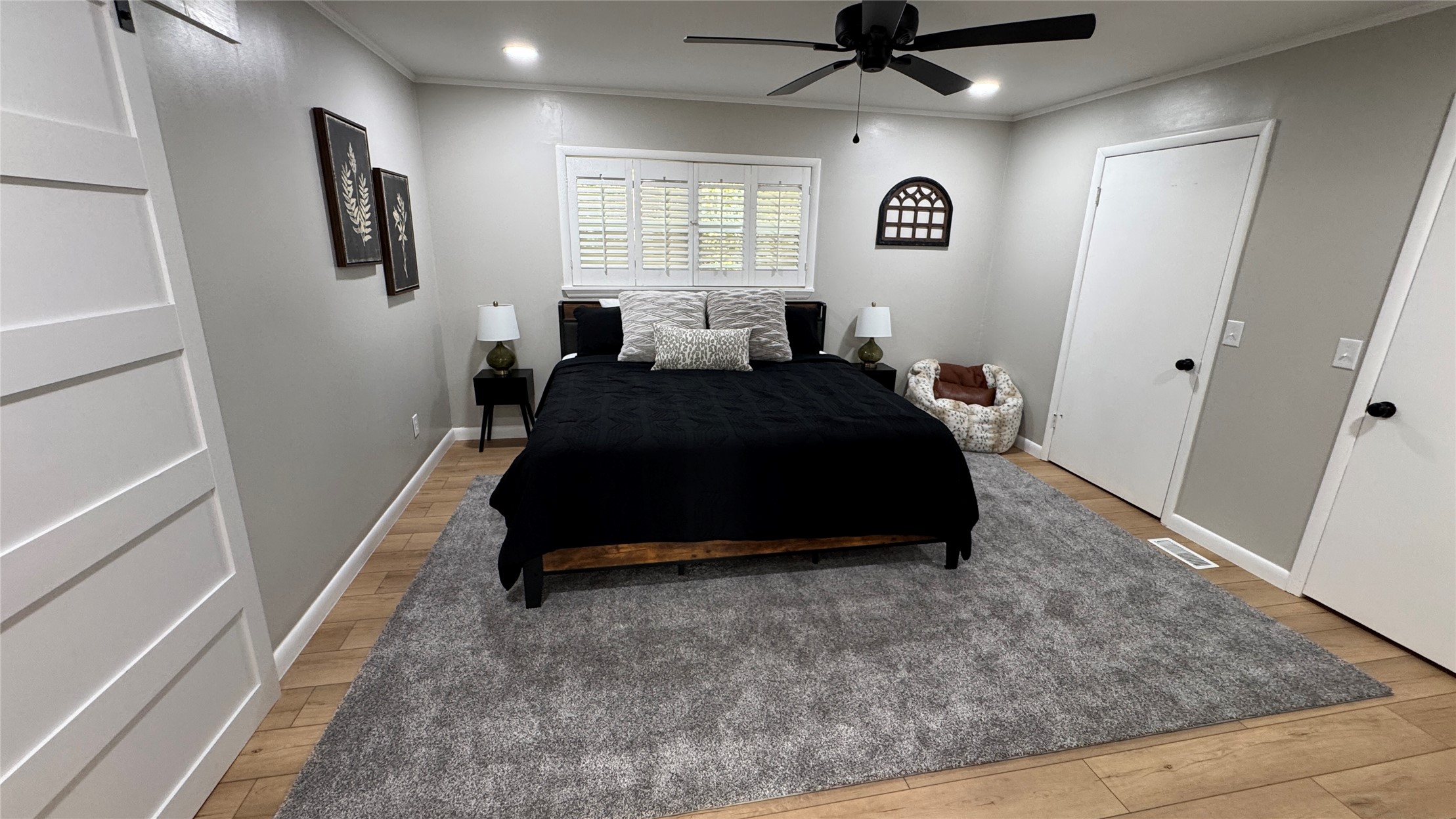 96358 South 4531 Road Vian, OK 74962 - Photo 33 of 58 Wood-finish flooring, recessed lighting, ceiling fan, white paneled doors, and a sliding barn door