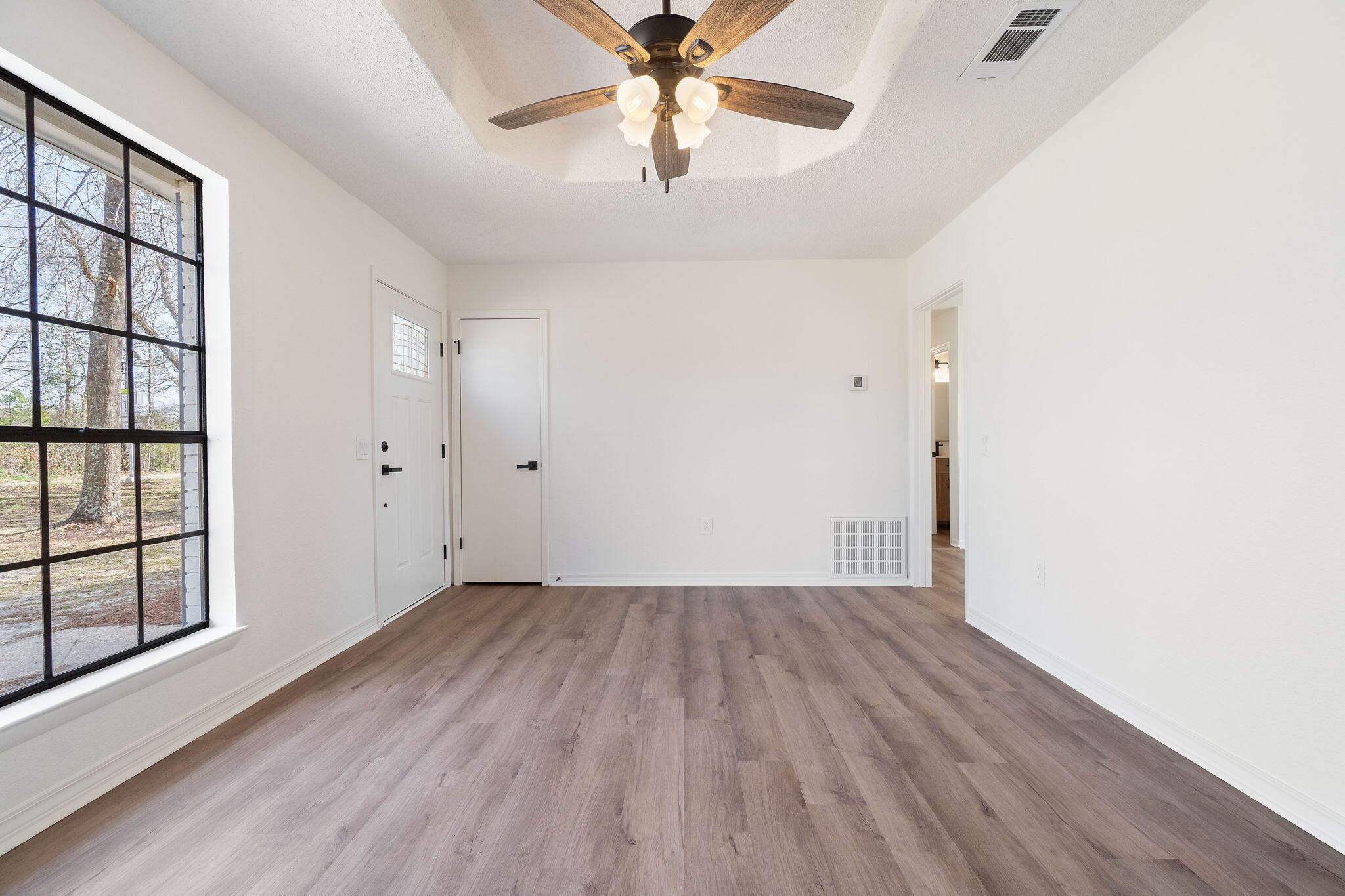 6118 Buckward Road Baker, FL 32531 - Photo 12 of 39 an empty room with windows and ceiling fan