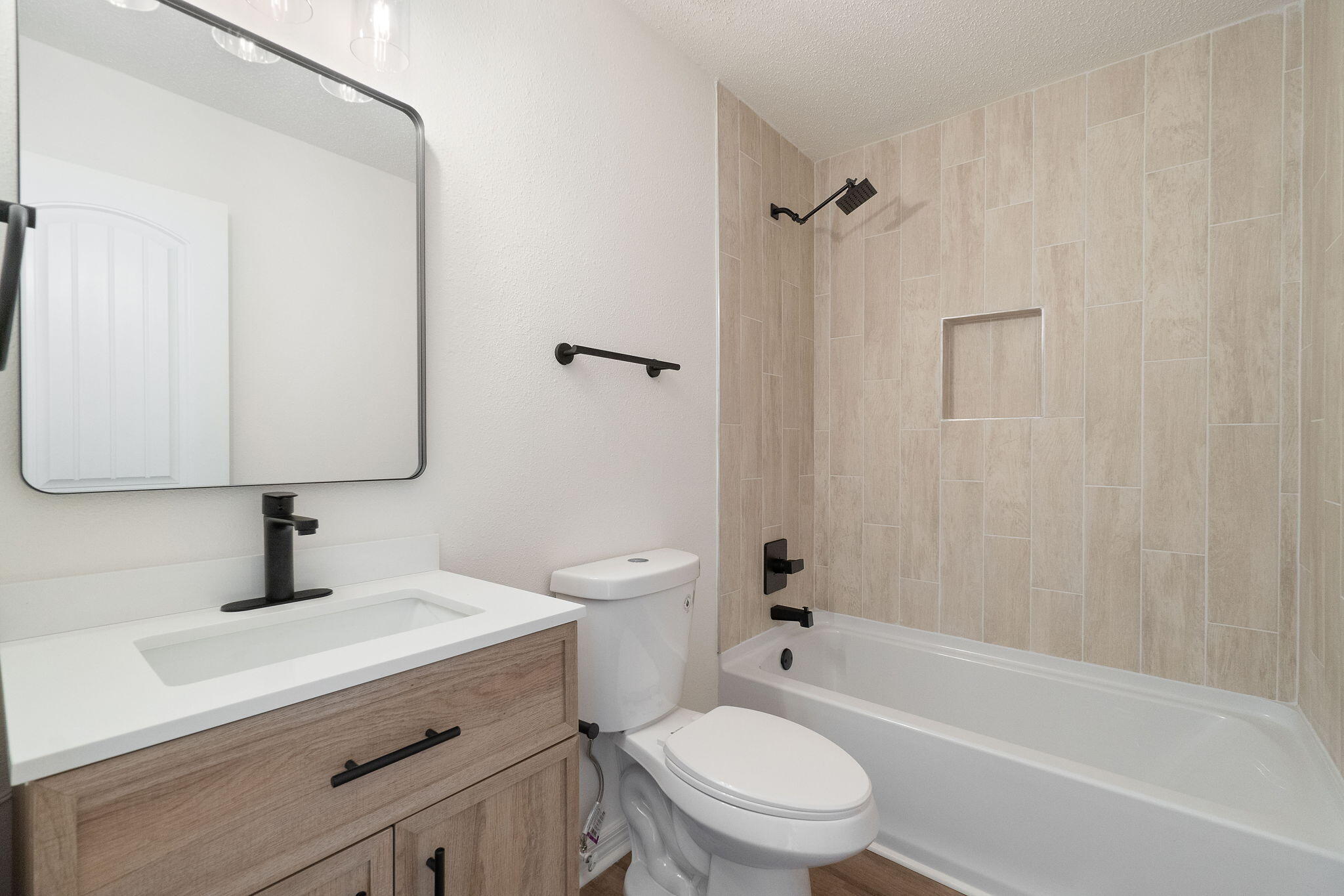 6118 Buckward Road Baker, FL 32531 - Photo 15 of 39 a bathroom with a bathtub shower sink vanity mirror and toilet