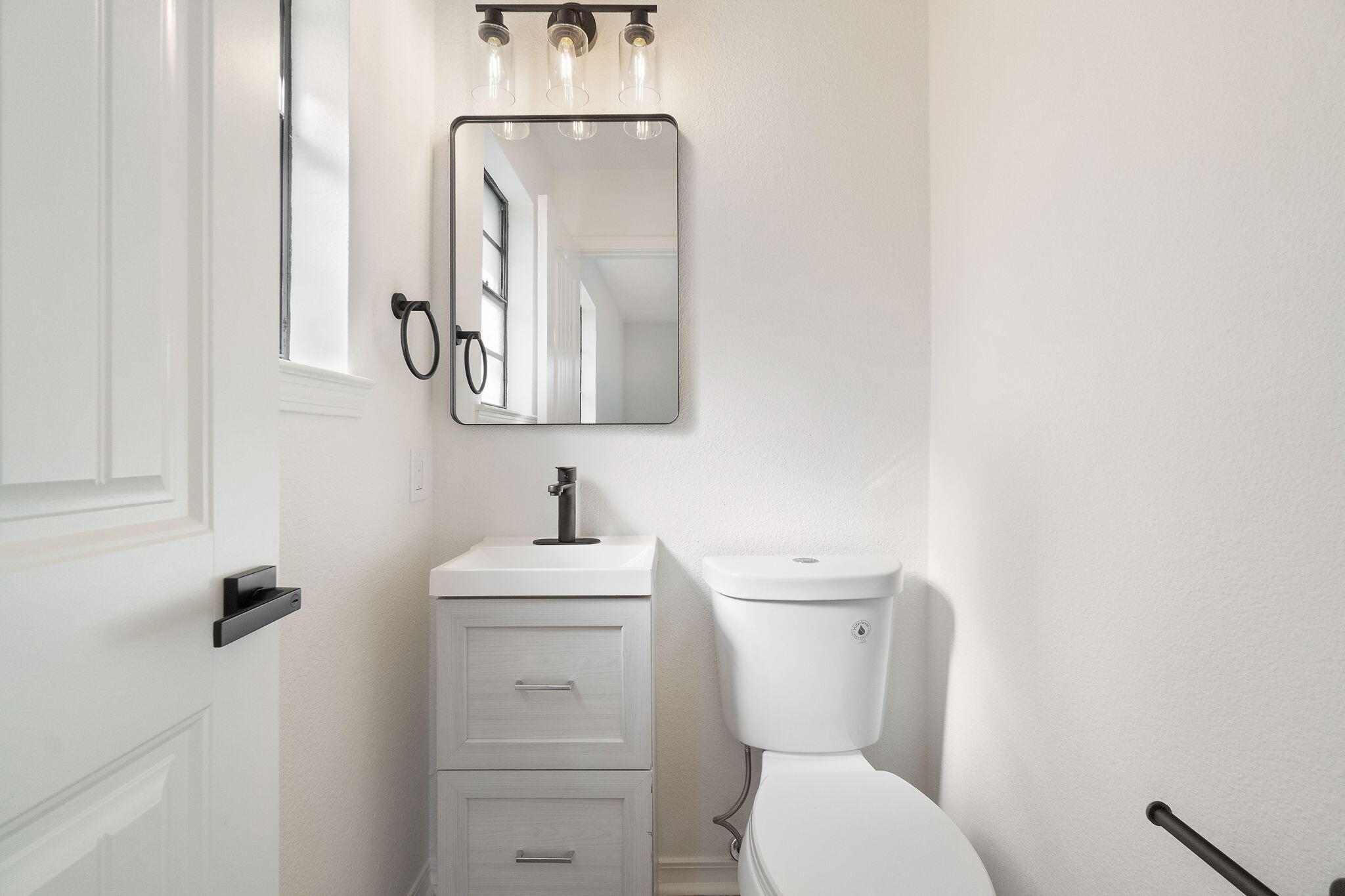 6118 Buckward Road Baker, FL 32531 - Photo 18 of 39 a bathroom with a toilet sink and mirror