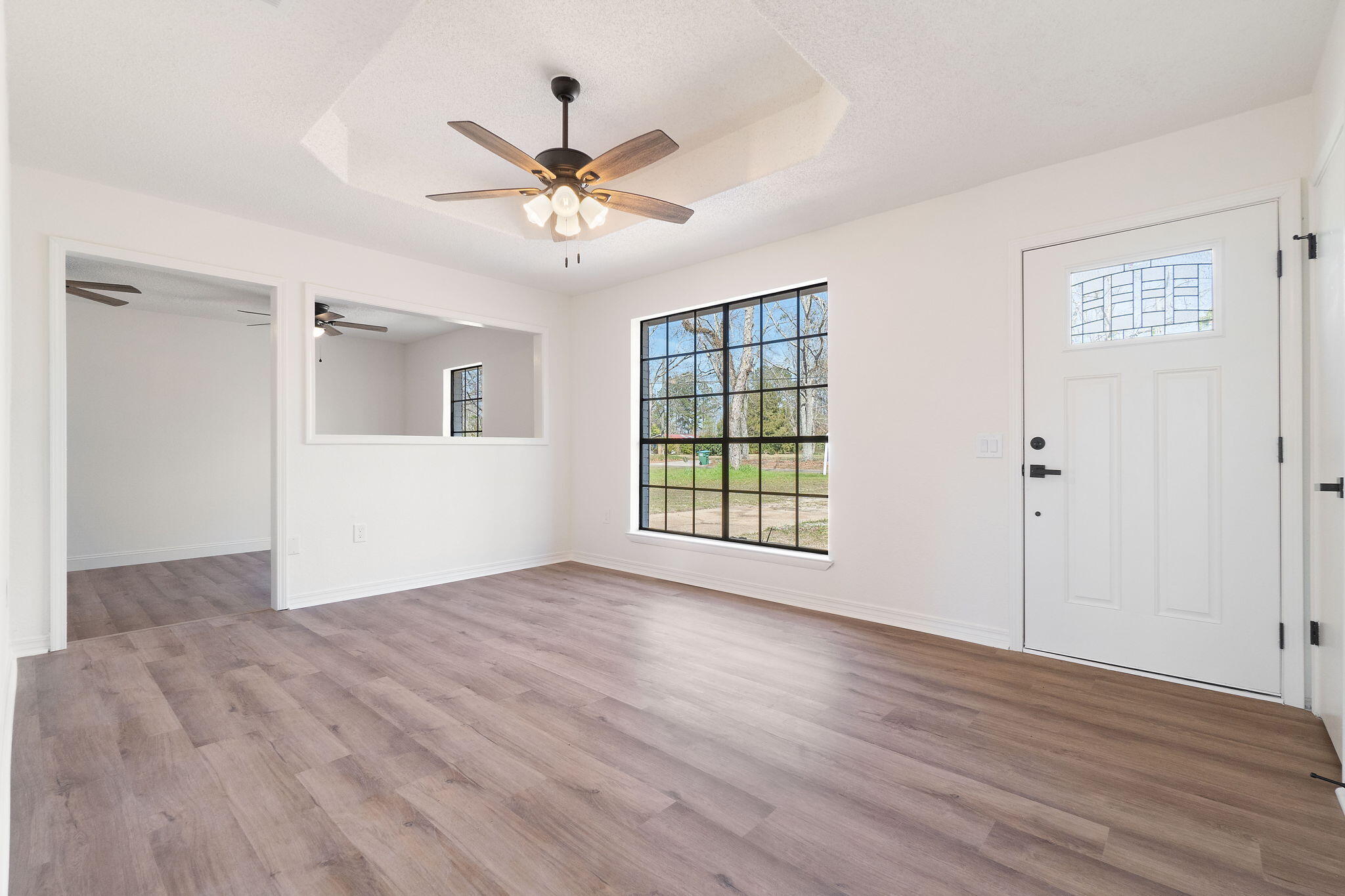 6118 Buckward Road Baker, FL 32531 - Photo 2 of 39 a view of an empty room with wooden floor and a window