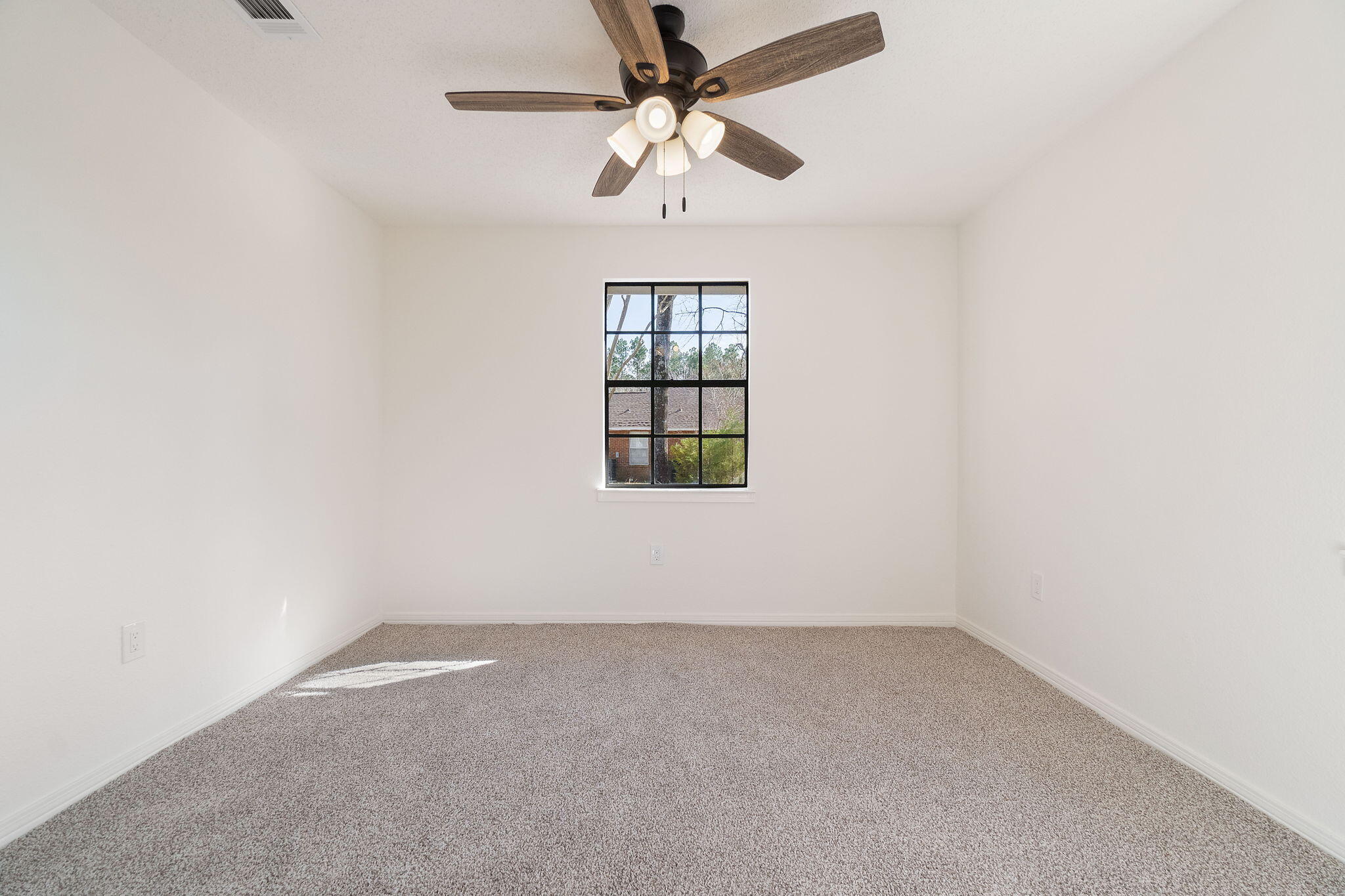 6118 Buckward Road Baker, FL 32531 - Photo 22 of 39 an empty room with a window and a ceiling fan