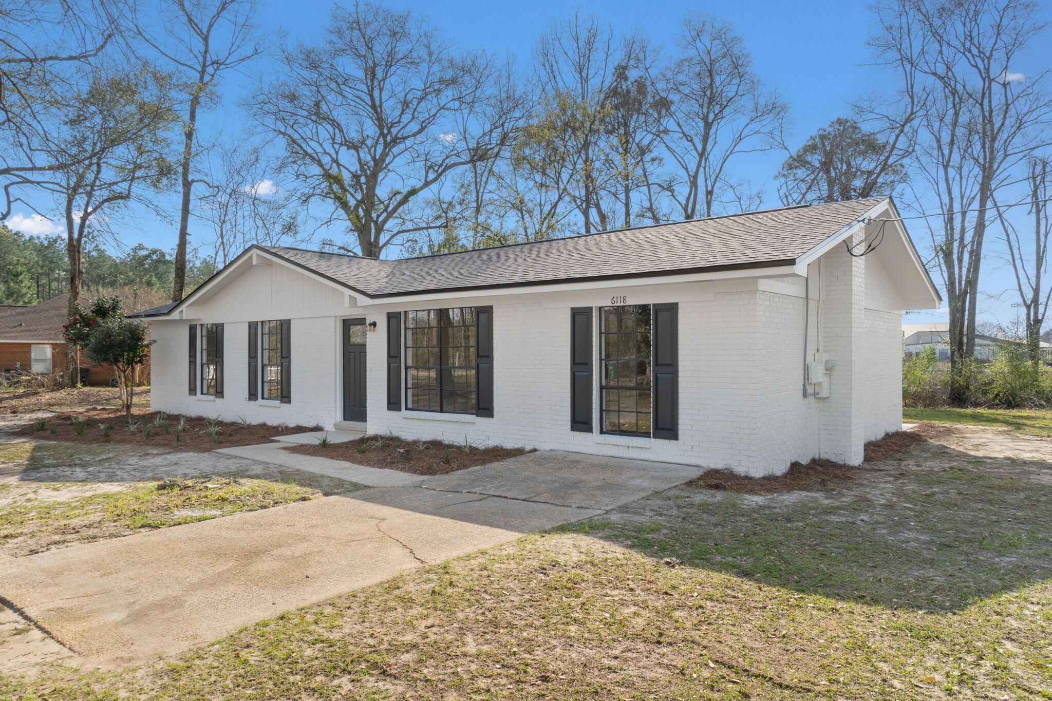 6118 Buckward Road Baker, FL 32531 - Photo 36 of 39 a front view of a house with a yard and garage