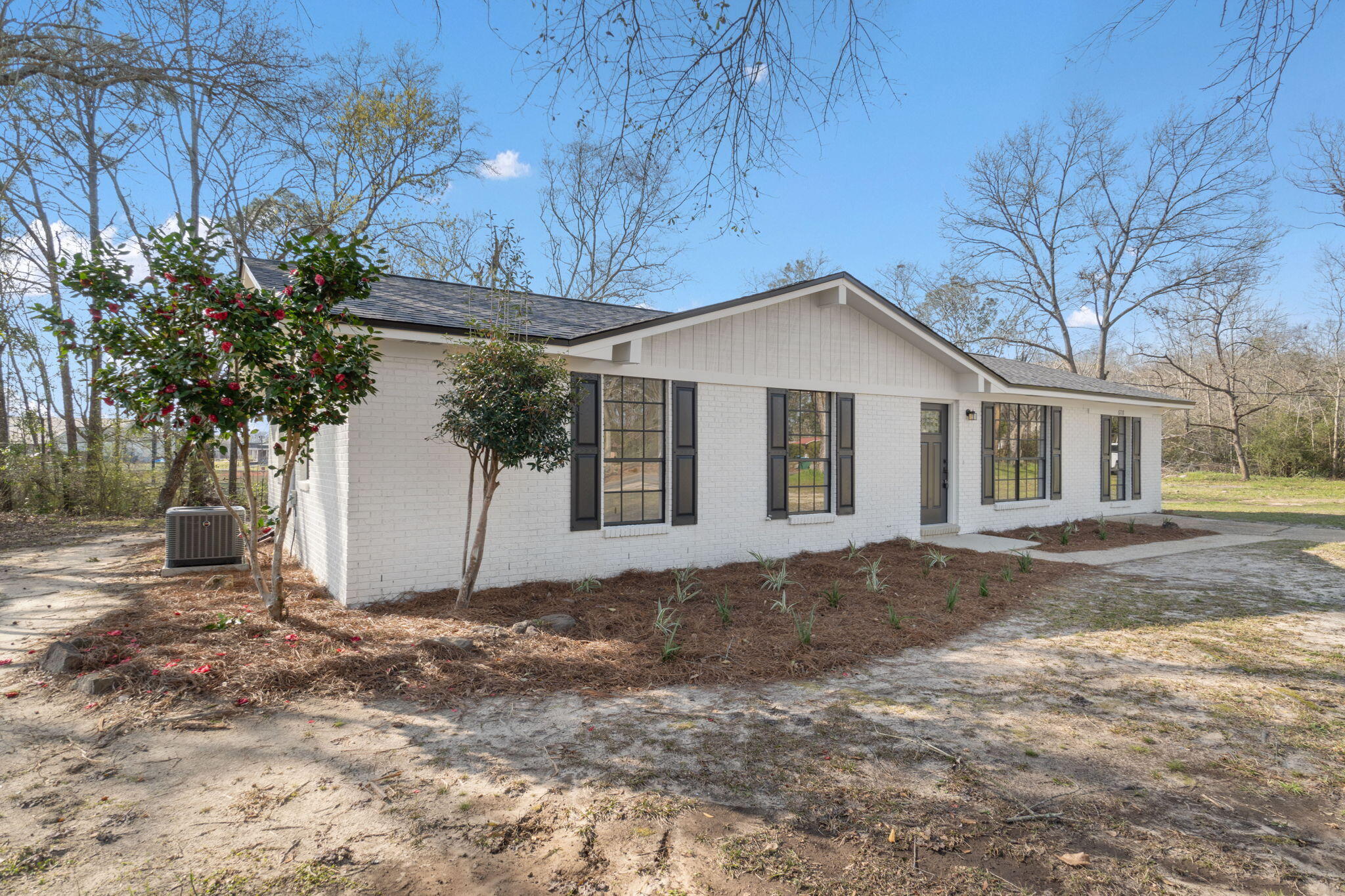 6118 Buckward Road Baker, FL 32531 - Photo 39 of 39 a front view of a house with a garden and trees