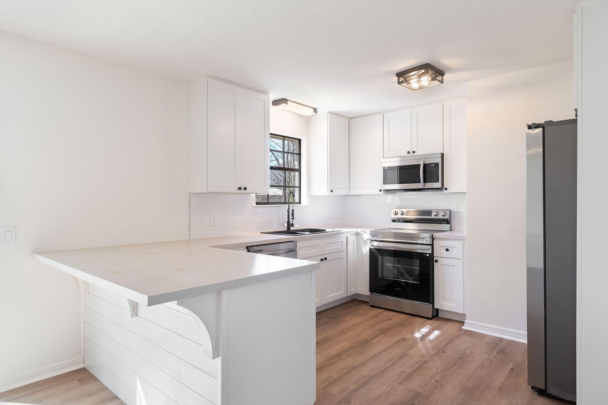 6118 Buckward Road Baker, FL 32531 - Photo 5 of 39 a kitchen with stainless steel appliances a sink stove and microwave