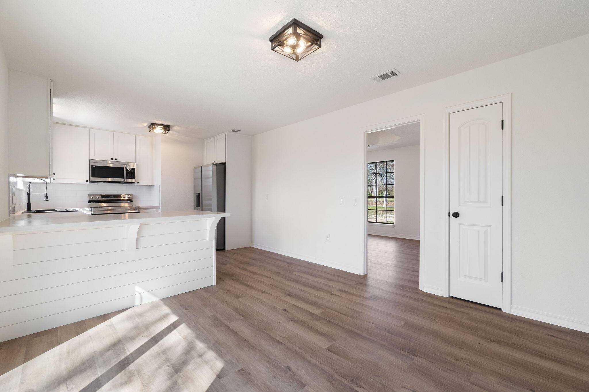 6118 Buckward Road Baker, FL 32531 - Photo 7 of 39 a view of kitchen with stainless steel appliances wooden floor and window