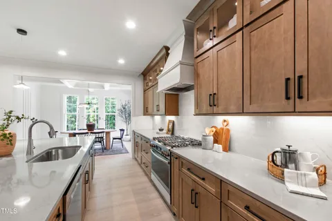 a large kitchen with stainless steel appliances kitchen island granite countertop a large counter top and stove