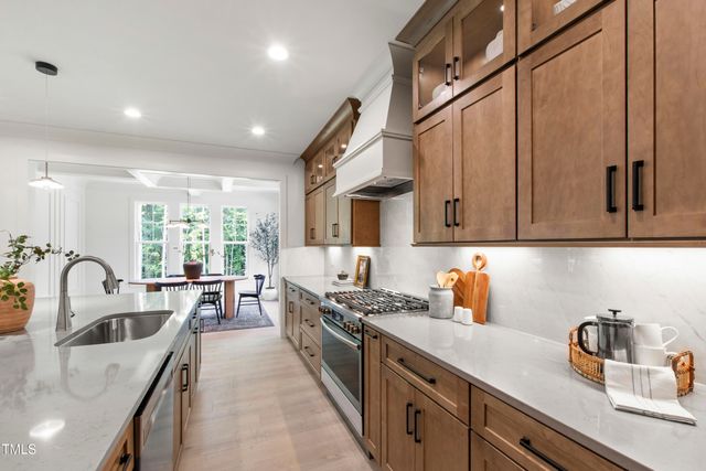 a large kitchen with stainless steel appliances kitchen island granite countertop a large counter top and stove