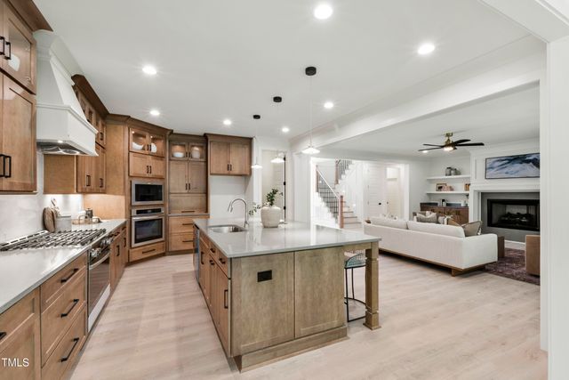 a kitchen with stainless steel appliances granite countertop a sink stove and cabinets