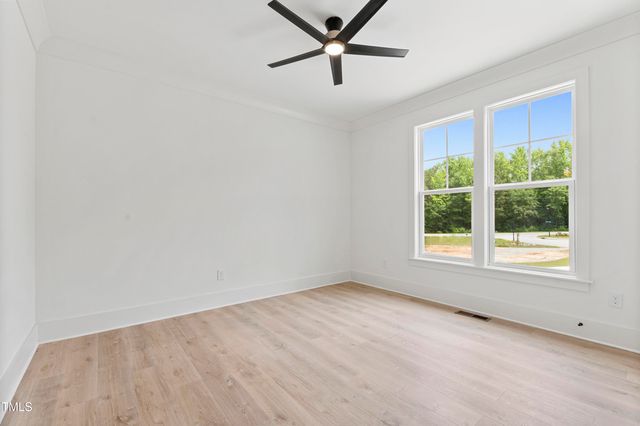a view of a livingroom with a ceiling fan & window