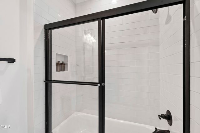 a living room with furniture a table and chairs next to a window