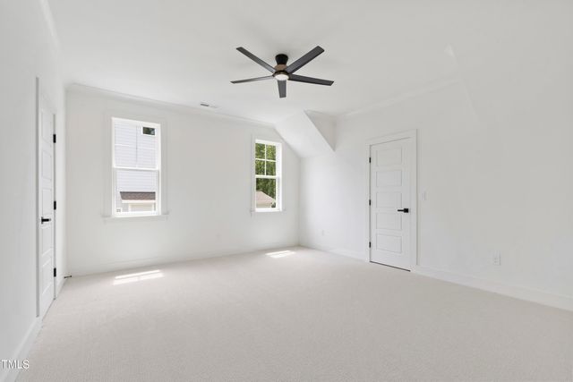 a view of a house with a big yard and large trees