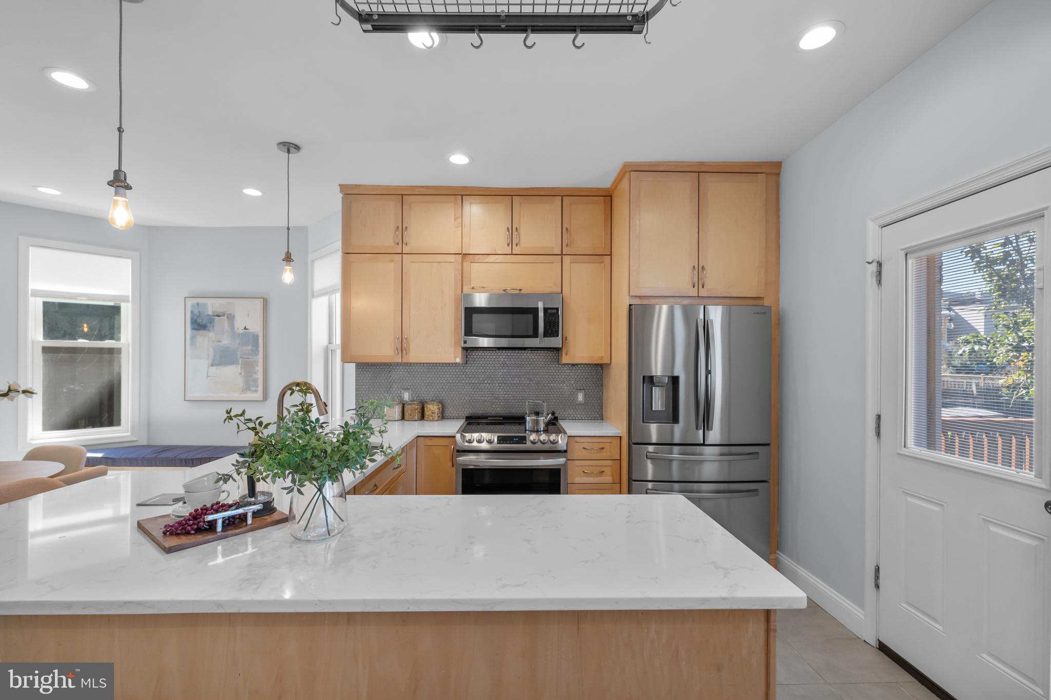 3916 5th Street Northwest Washington, DC 20011 - Photo 15 of 51 a kitchen with kitchen island a counter top space cabinets stainless steel appliances and a window