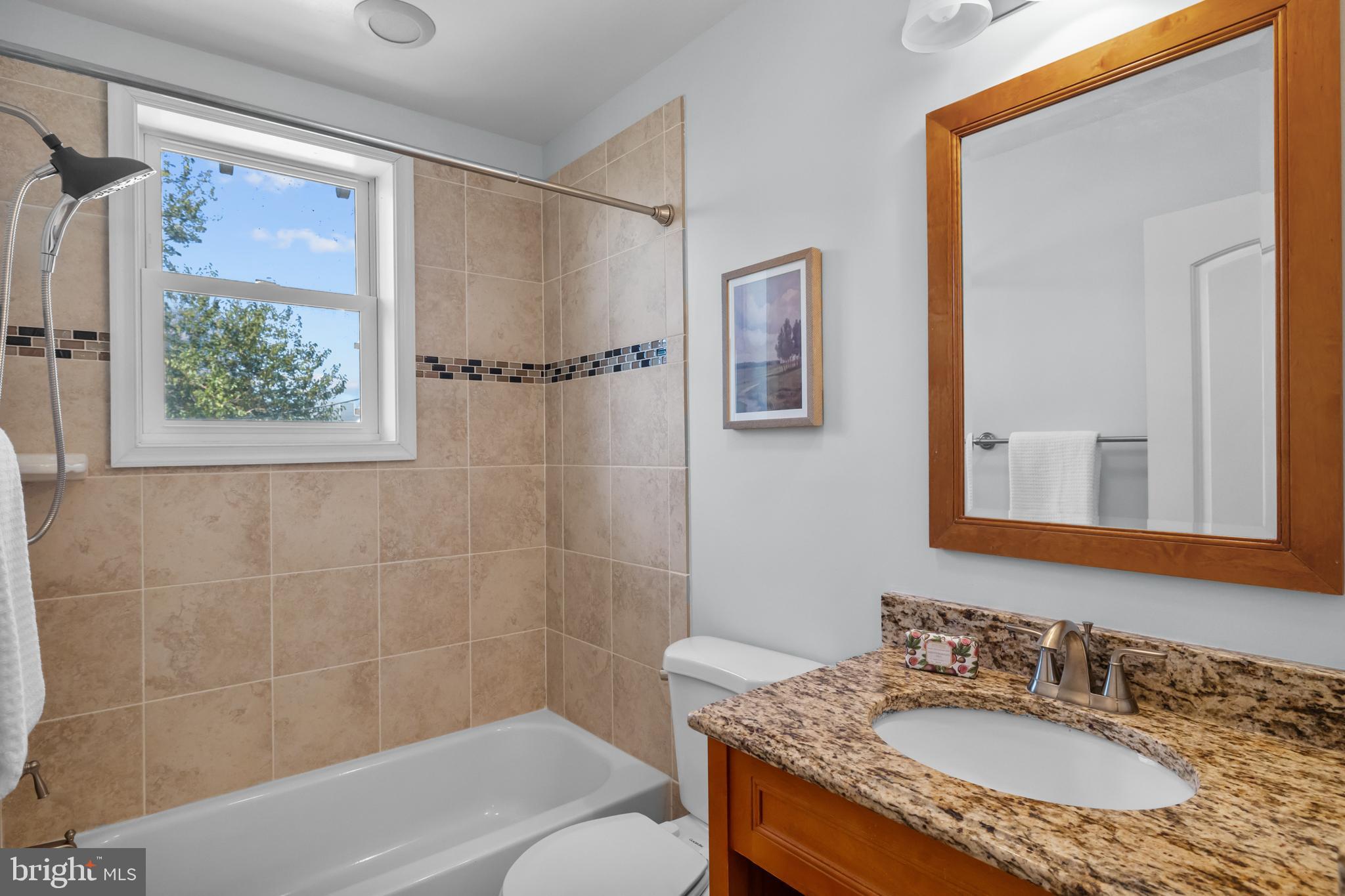 3916 5th Street Northwest Washington, DC 20011 - Photo 27 of 51 a bathroom with a granite countertop sink a mirror a shower and a bathtub