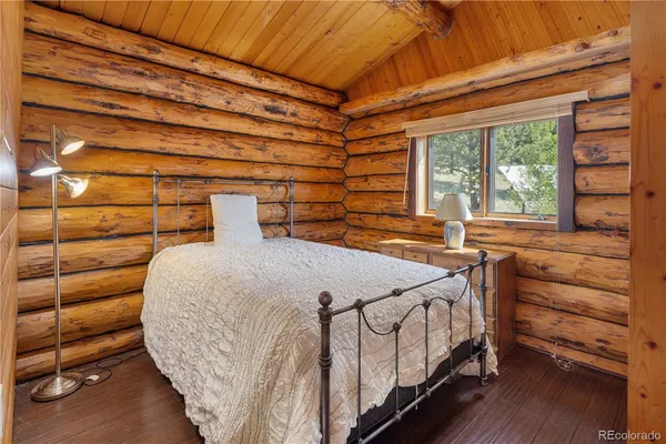 a bedroom with a bed and a flat tv screen