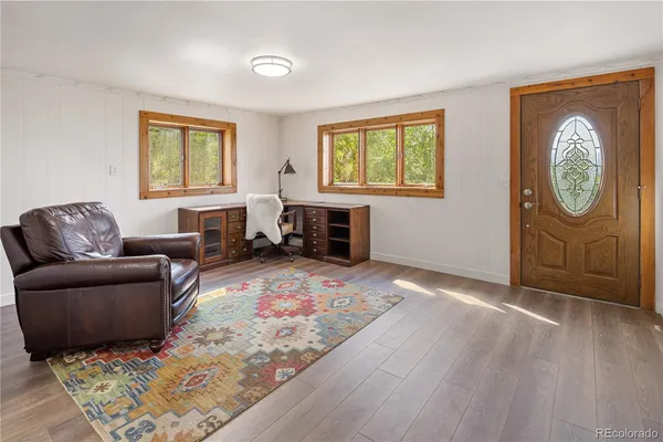 a view of wooden floor and windows in a room