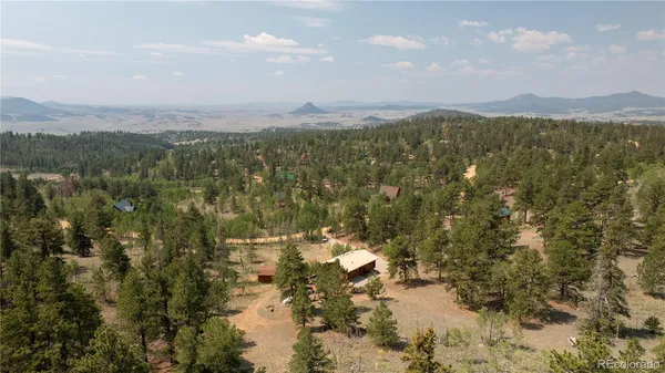 a view of a house with a yard and mountain view