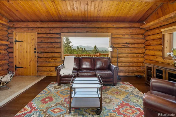 a living room with stainless steel appliances kitchen island granite countertop furniture and a kitchen view