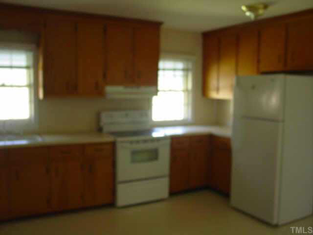 1813 Bahama Road Bahama, NC 27503 - Photo 2 of 3 a kitchen with a window and cabinets