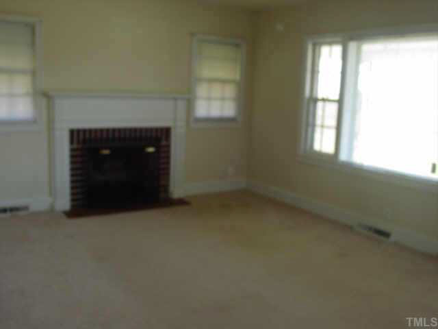 1813 Bahama Road Bahama, NC 27503 - Photo 3 of 3 an empty room with a fireplace