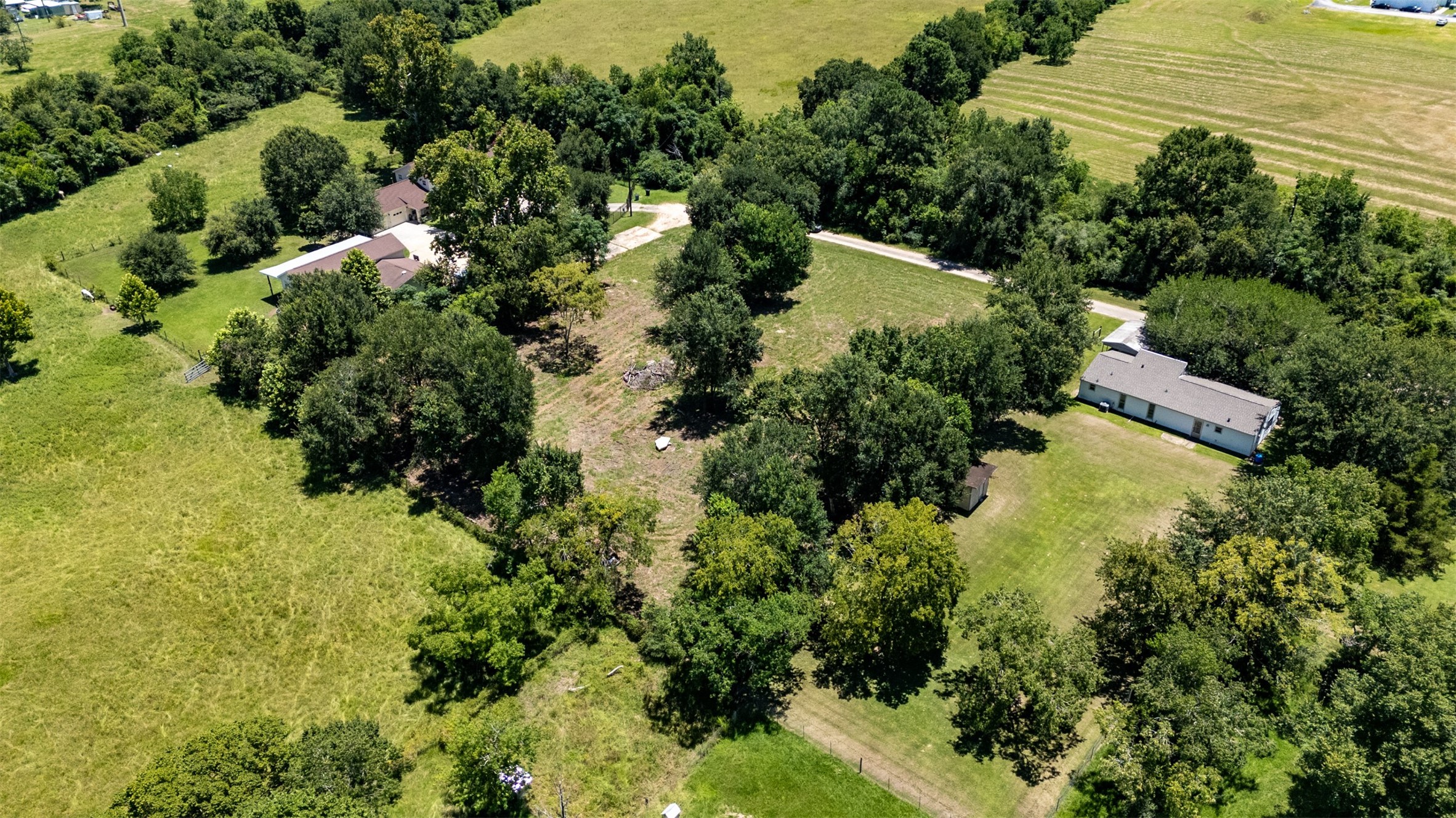 1533 South Cherry Street Tomball, TX 77375 - Photo 6 of 10 an aerial view of residential house with outdoor space and trees all around