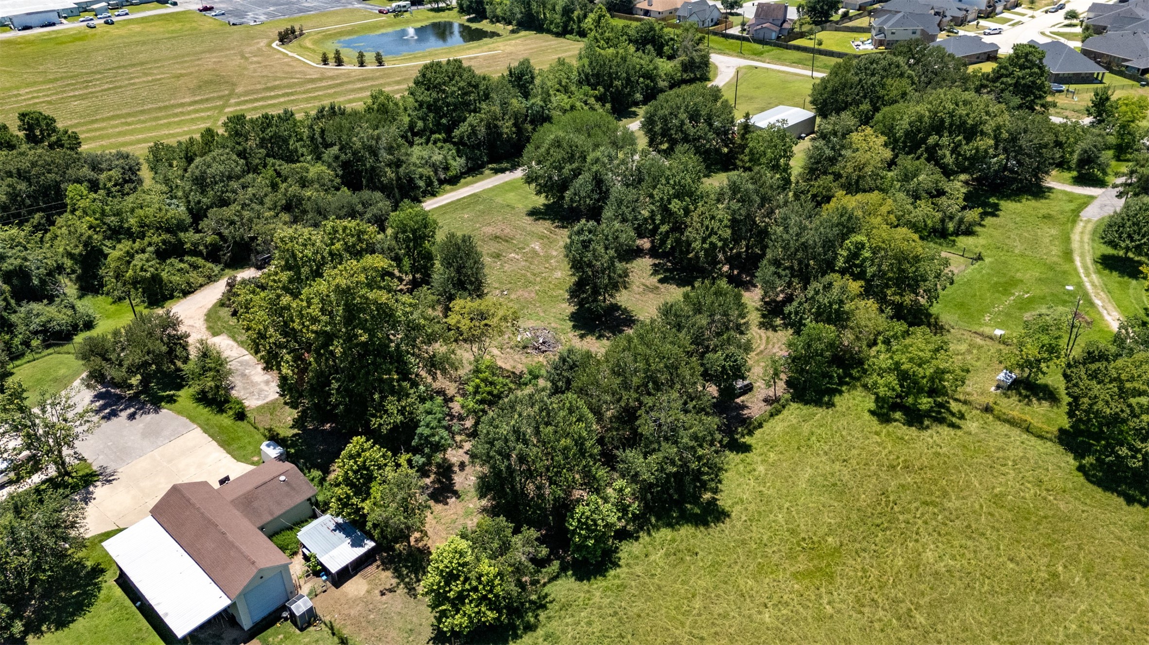 1533 South Cherry Street Tomball, TX 77375 - Photo 8 of 10 an aerial view of residential houses with outdoor space and trees