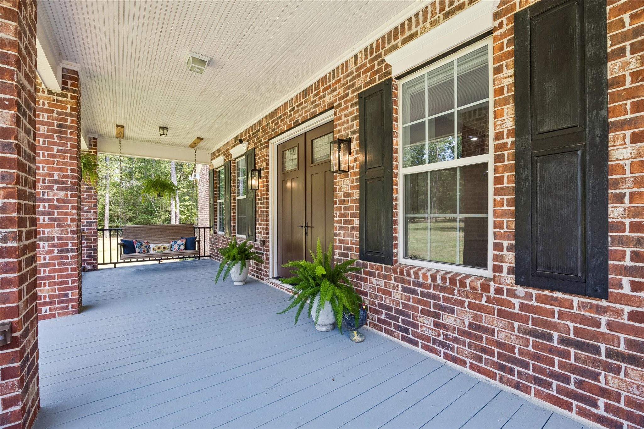 Unwind on the spacious front porch, perfect for enjoying serene views and watching deer gracefully pass by.