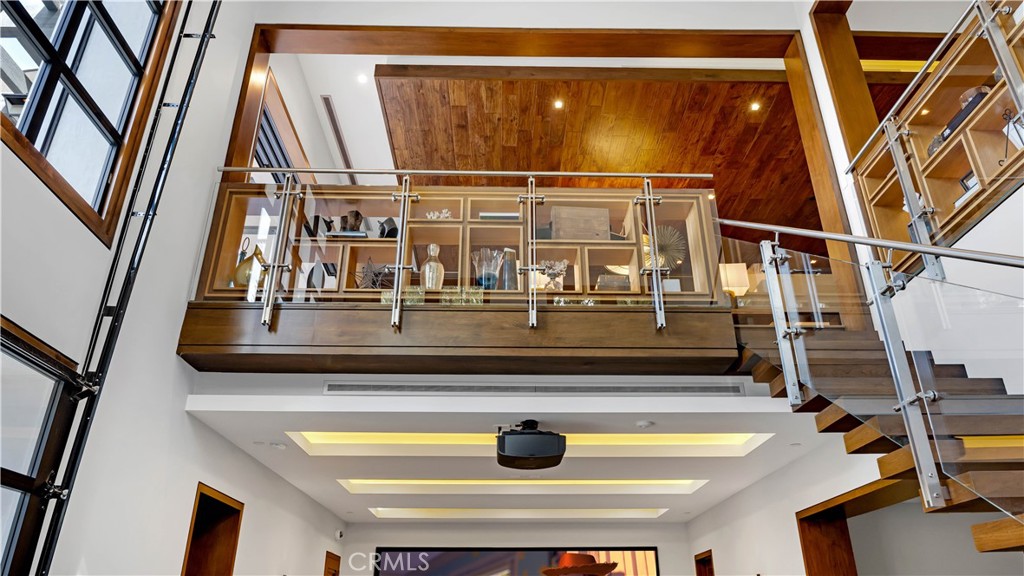 2 Thomas Road Ladera Ranch, CA 92694 - Photo 52 of 69 A view of the custom woodwork upstairs while you are in the media room. The glass and metal stair railing is one of a kind.