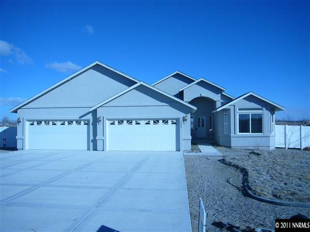 1880 Heidi Road Fallon, NV 89406 - Photo 1 of 13 a front view of a house with a yard and garage