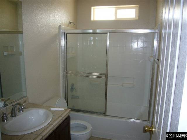 1880 Heidi Road Fallon, NV 89406 - Photo 4 of 13 a bathroom with a granite countertop sink toilet and shower