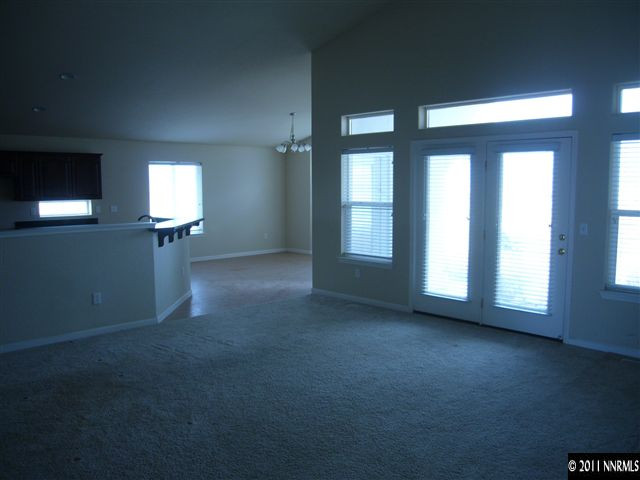 1880 Heidi Road Fallon, NV 89406 - Photo 8 of 13 an empty room with windows and fireplace