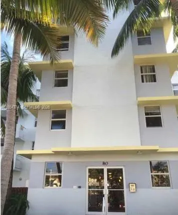 a front view of multi story residential apartment building with yard